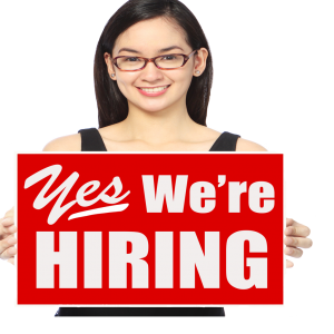 Girl holding a now hiring sign
